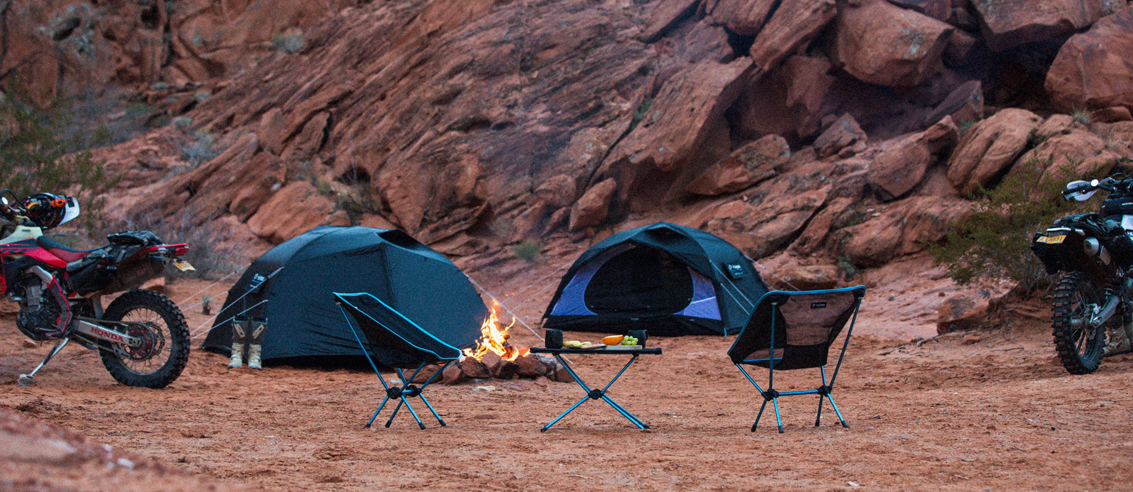 Motorcycle camp scene with tents, chairs and campfire Motorcycle camp scene with tents, chairs and campfire
