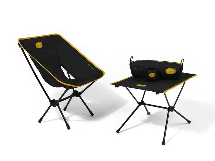Helinox x Vibram black camp chair and table set with yellow trim on a white background