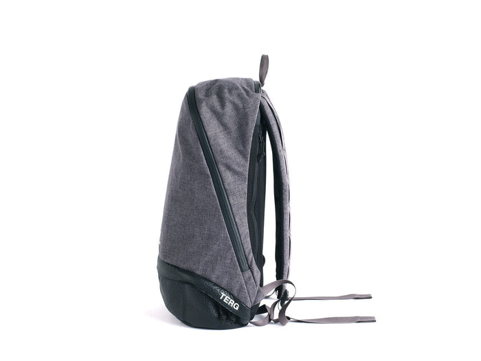 Side profile of a dark grey and black TERG backpack on a white background