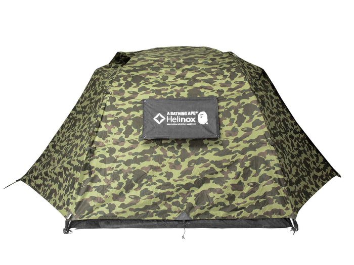 Green camo dome tent featuring Helinox x BAPE logo patch on a white background