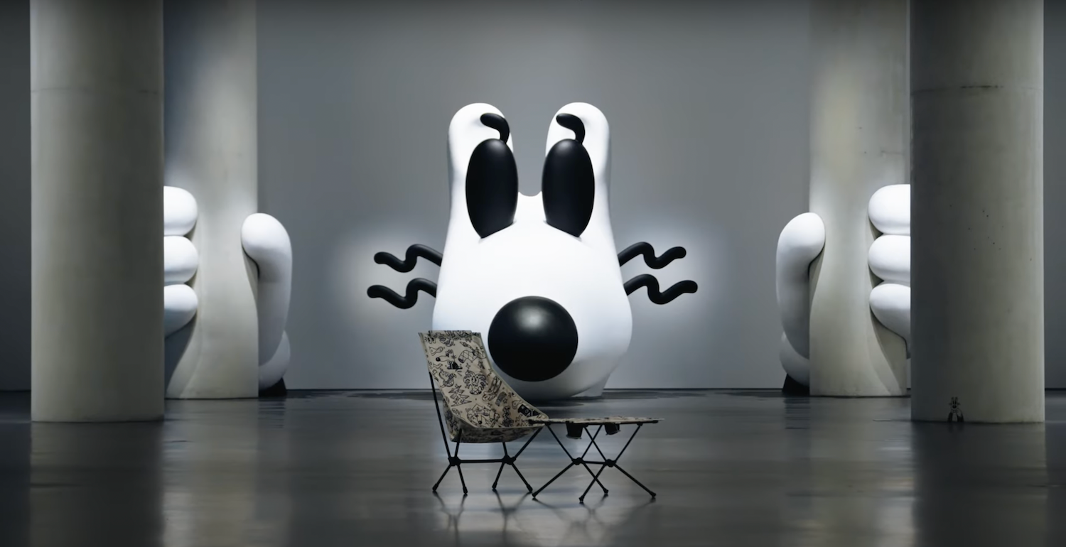 Camp chair and table in front of steven harrington installation 