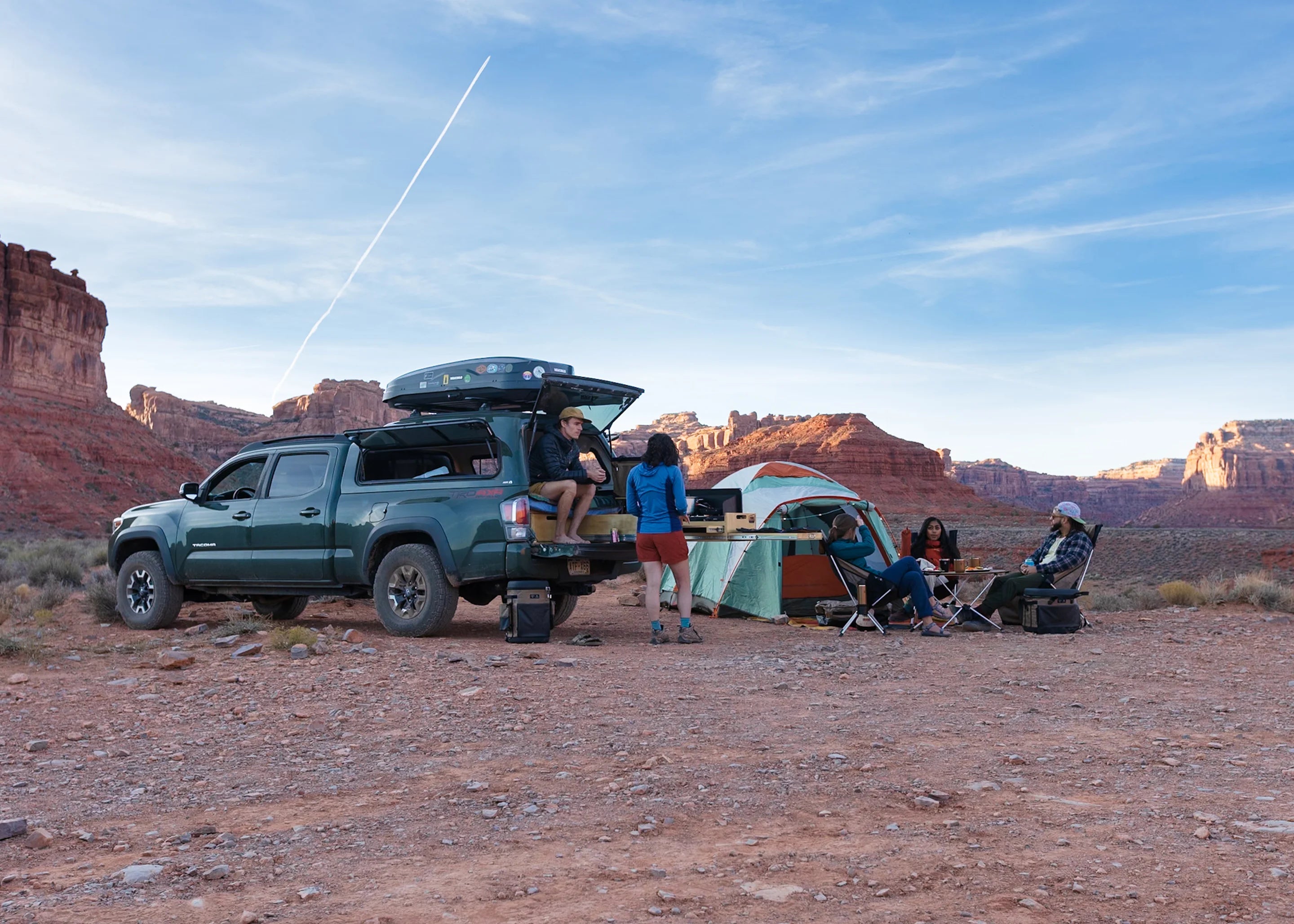 Truck, tent and Helinox camp setup in a desert canyon at dusk
