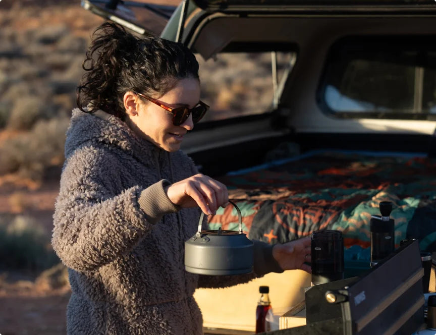 Camper pouring coffee with an OXO brewing set