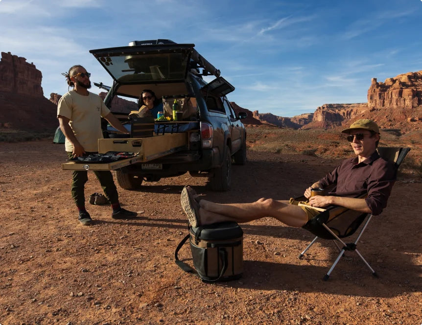 Friends at a truck campsite in the desert